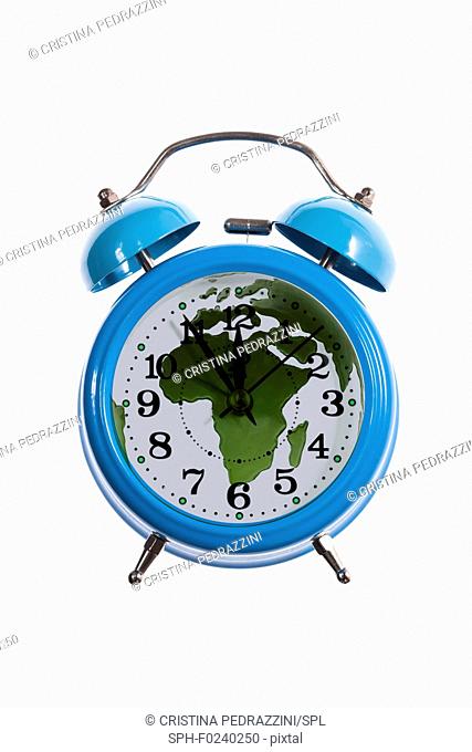 Alarm clock and world map with africa. Composite image depicting doomsday clock