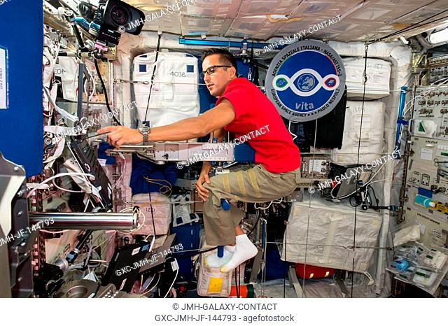 Astronaut Joe Acaba calculates his mass inside the Columbus laboratory module using the Space Linear Acceleration Mass Measurement Device (SLAMMD)