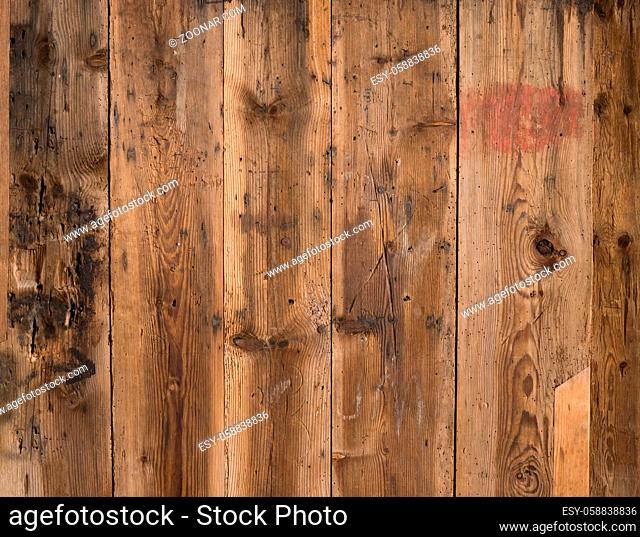 Natural brown barn wood wall. Wall texture background pattern. Wood planks, boards are old with a beautiful rustic look, style and woodworm holes