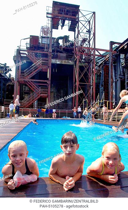 Children bathe in two industrial containers who have been re-organised as swimming pools in the middle of the area of the old cokery Zollverein in Essen on the...