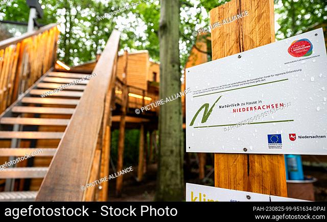 PRODUCTION - 17 August 2023, Lower Saxony, Göhrde: ""Naturally at home in Lower Saxony"" is one of the words on a sign at the tree house hotel