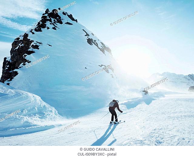 Young female skier skiing in snow covered landscape, Alpe Ciamporino, Piemonte, Italy