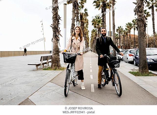 Portrait of couple with e-bikes on a promenade
