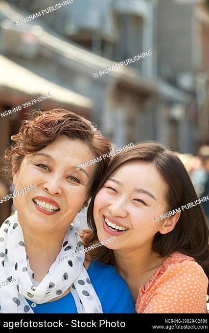 Portrait of mother and daughter on the street in Beijing, close up