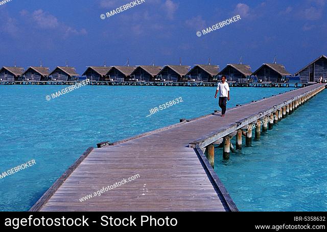 Man on landing stage of White Sands Resort, Ari atol, Maldives, Man on landing stage of White Sands Resort, Ari atoll, Maldives, Asia