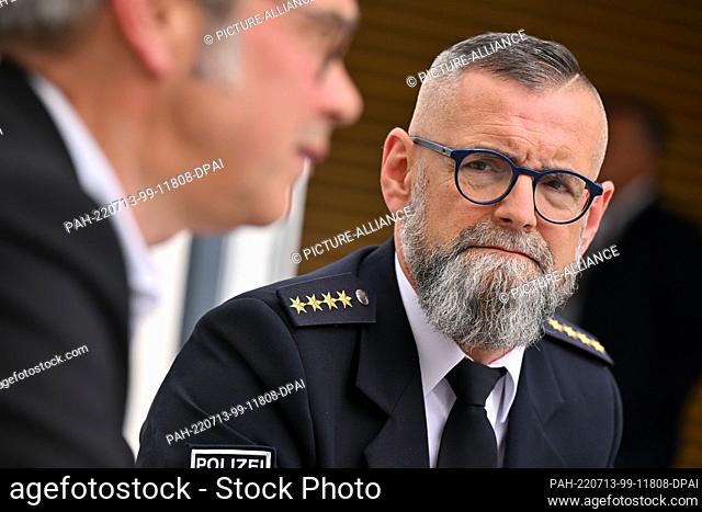 13 July 2022, Thuringia, Erfurt: Dirk Löther, state police chief, sits next to Thuringia's interior minister, who is speaking in the Thuringian state parliament...