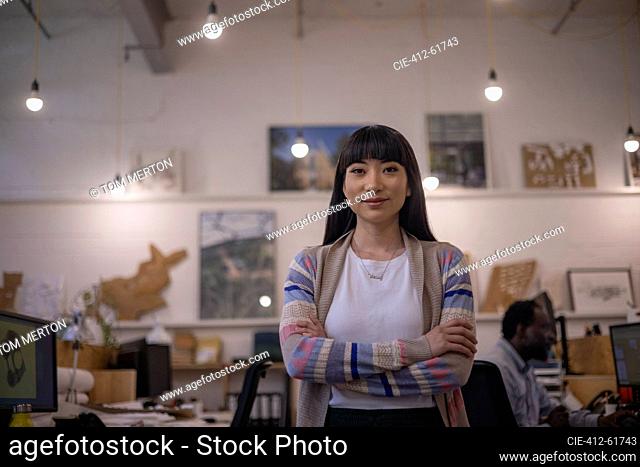 Portrait confident female designer standing in office