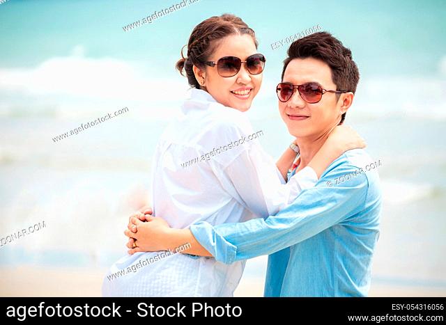 Happy Young Adult Couples in love outdoor at beach