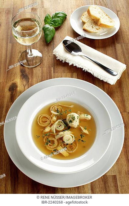 Wedding soup, beef stock with dumplings, sliced pancakes and egg served with white bread and white wine