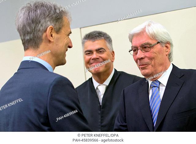 Former BayernLB (Bavarian State Bank) chairman Michael Kemmer (L) greets Werner Schmidt (R), the former BayernLB manager
