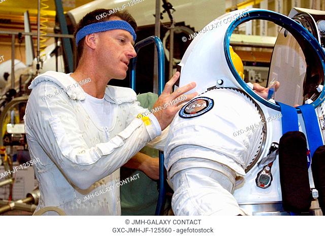 Attired in his thermal undergarment, astronaut C. Michael Foale prepares to don a Mark III advanced space suit technology demonstrator as he participates in a...