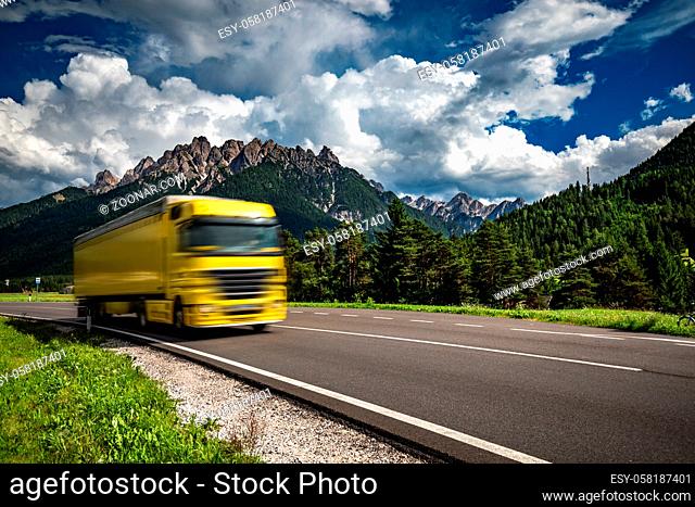 Fuel truck rushes down the highway in the background the Alps. Truck Car in motion blur