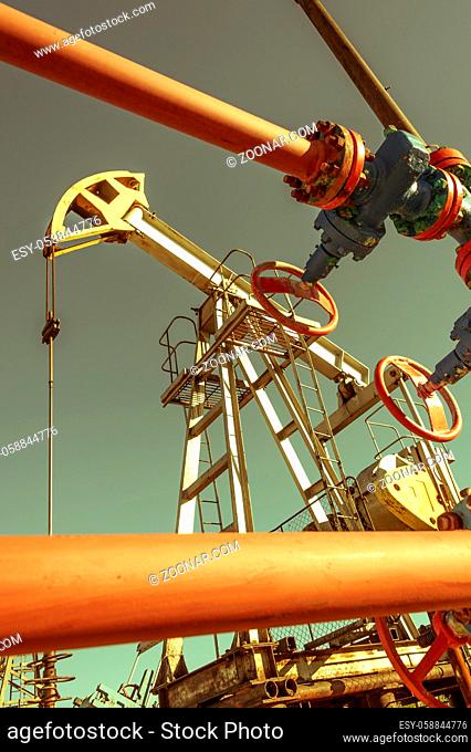 Oil pump rig operation on the platform in oil and gas industry. Pumpjack, industrial equipment. Oilfield site, oil pump are running