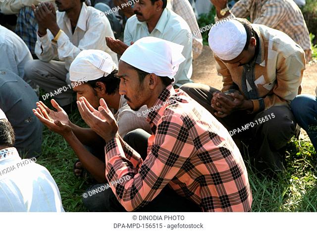 People praying during burial of their family members who died in powerful bomb blast on 29th September 2008 at Malegaon ; Maharashtra ; India NO MR