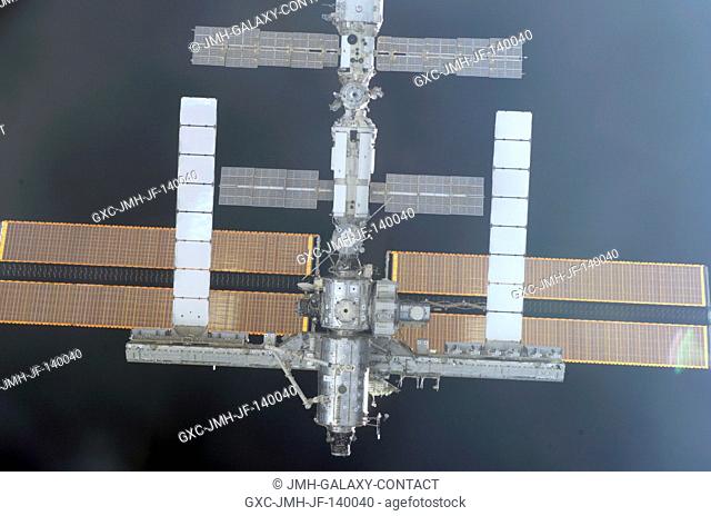 Backdropped by the blackness of space, the International Space Station was photographed by an STS-114 crewmember aboard Space Shuttle Discovery during...