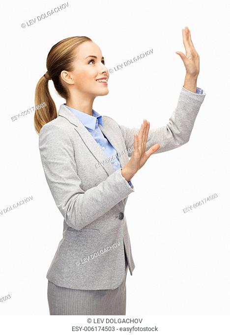 business and future technology concept - smiling businesswoman pointing to something or pressing imaginary button