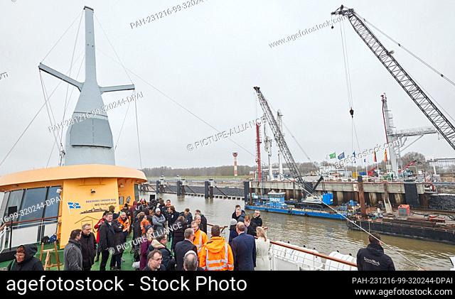 16 December 2023, Lower Saxony, Stade: Guests stand on the MS Helgoland during the opening of the jetty for liquefied gases (AVG)