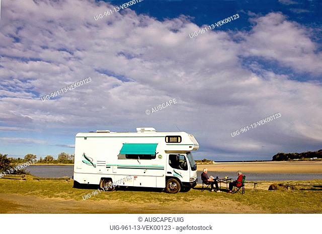 Motorhome set up for camping beside Burrill Lake, Burrill Lake, New South Wales, Australia