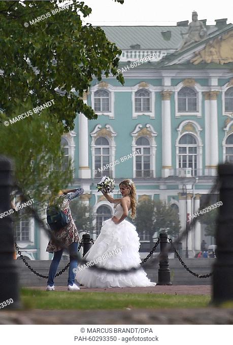 A bride poses in front of the Hermitage in St. Petersburg, Russia, 23 July 2015. Preliminary Draw FIFA World Cup 2018 will take place on 25 July in St