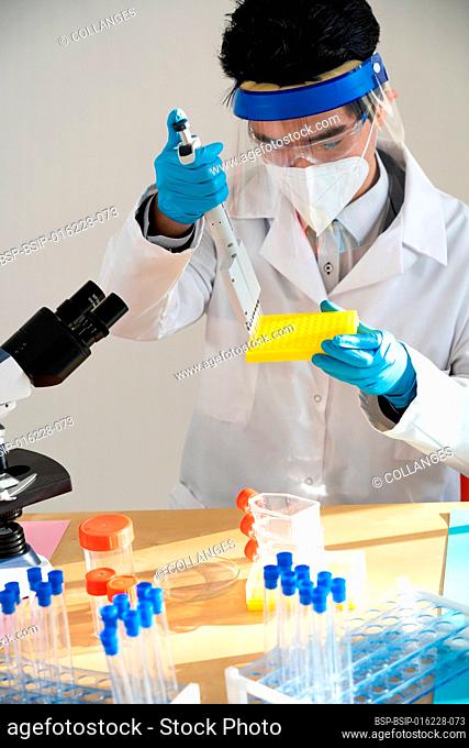 Laboratory assistant conducting experiments for laboratory research