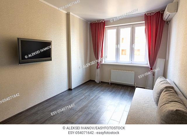 Interior of a modest room in an apartment for rent