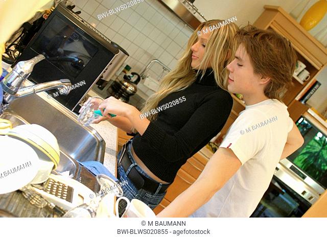couple washing the dishes in the kitchen