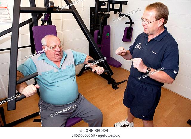 Access to services, Fitness instructor and disabled man in the gym, using Chest Press