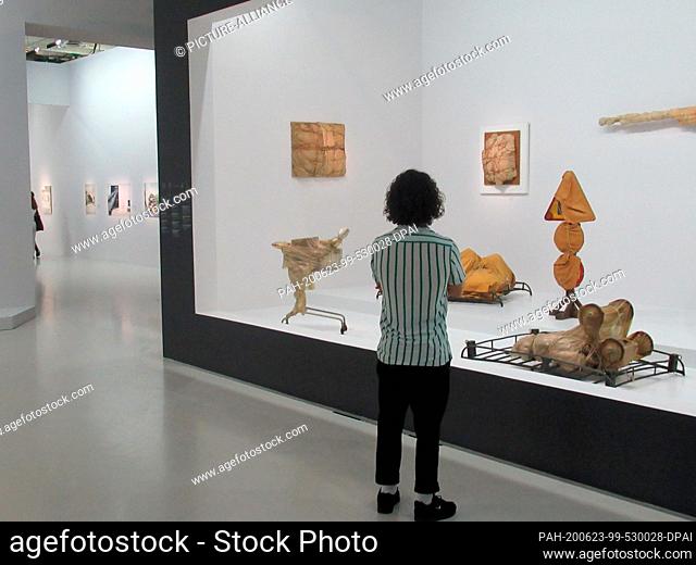 21 June 2020, France, Paris: A woman looks at packaging art works by Christo at the Centre Pompidou in the exhibition ""Christo and Jeanne-Claude