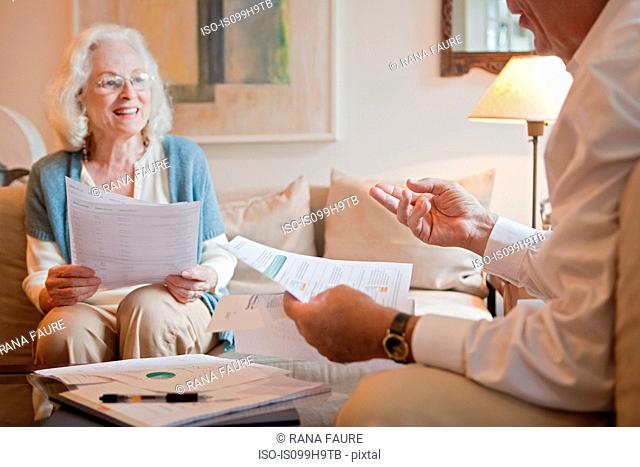 Senior couple discussing paperwork at home