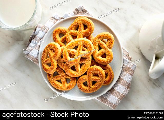 Sweet cookies in the shape of a pretzel on plate. Top view