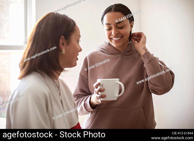 Young women friends drinking tea