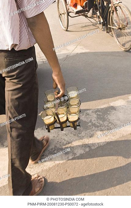 Rear view of a tea vendor, Delhi, India