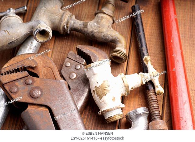 plumbing tools lying with old pipes and faucets