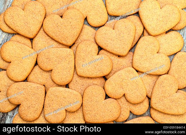 Heart shaped gingerbread cookies on wooden background
