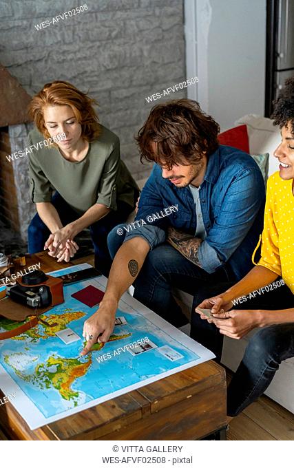 Friends meeting to plan vacations, checking map