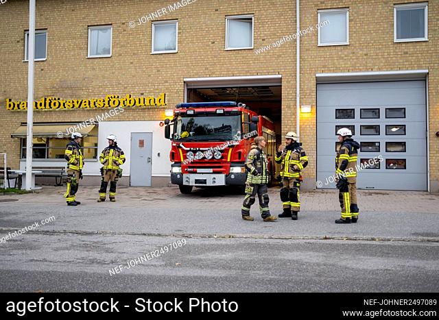 Firefighters in front of fire station