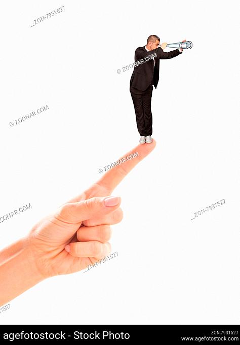Businesman looking through tube in the distance isolated on white. Businessman trying to overcross his competitors with the help of woman