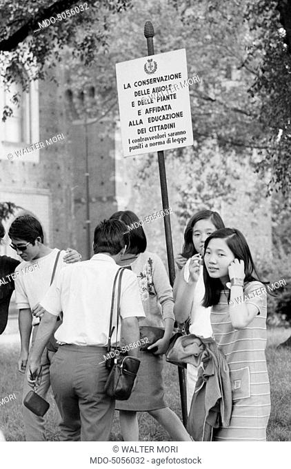 Some Asian tourists waiting for visiting the Sforza Castle in Milan on August 15th. Milan, 15th August 1968
