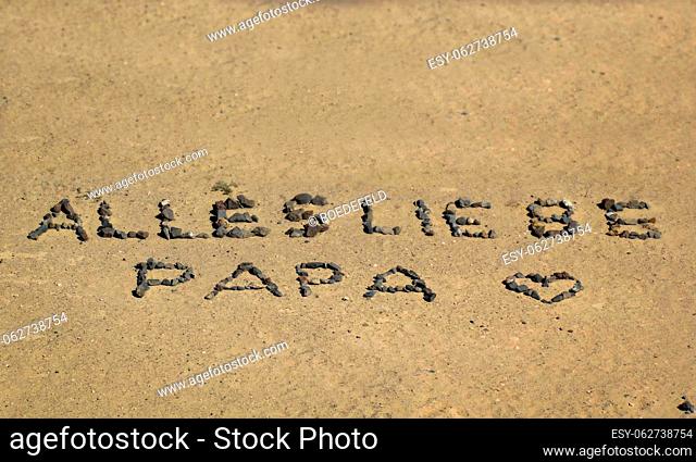 In the sand was left a special greeting to dad. ""All love dad"""""