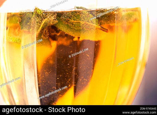 Carbonated soda water or juice with lime and mint in a glass jug. Macro closeup