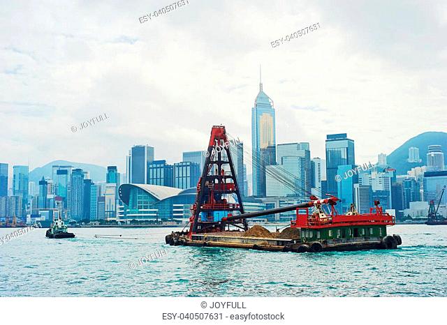 Barge in front of business district in Hong Kong. Some 456, 000 vessels arrived in and departed from Hong Kong during the year
