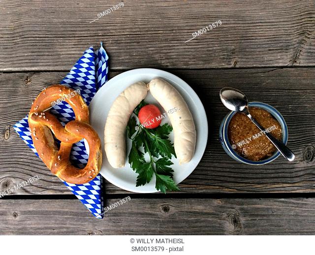 Weisswurst and pretzel for a traditional breakfast to be served and eaten before 10 o`clock in Bavaria, Germany, Europe