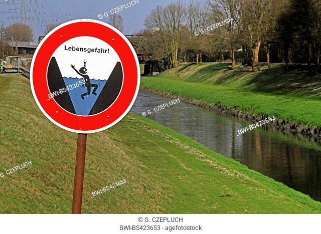 warning sign of drawning and open waste water canal Emscher , Germany