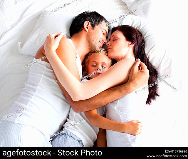 Lovely family sleeping on a bed