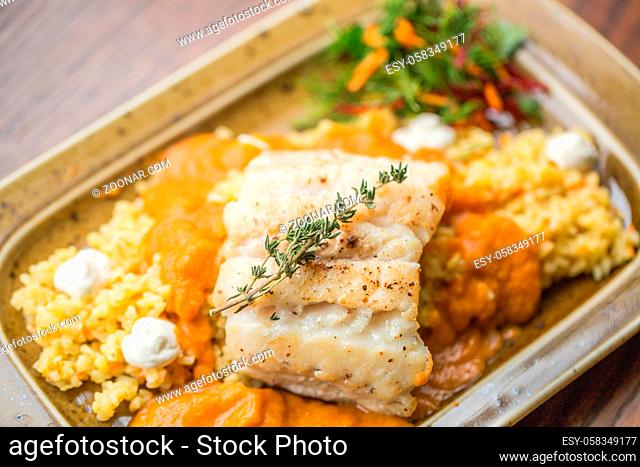 Fish in batter with fresh farm vegetables. fillet of tilapia fish in batter. Baked fish garnished with potatoes and vegetables