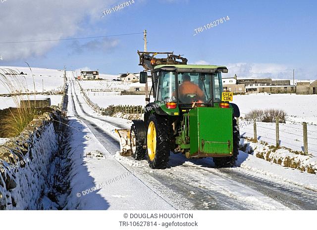 ROADS TRANSPORT Farm tractor snowplough clearing snow Orkney country roads