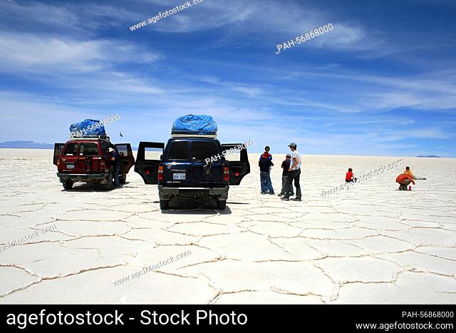 Tourists on a jeep tour look at the Salar de Uyuni, near Uyuni, Bolivia, taken on October 17th, 2009 during a break from driving