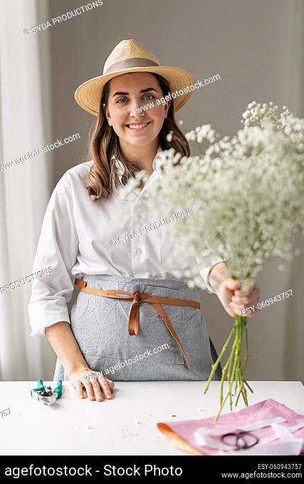 happy woman with gypsophila flowers at studio