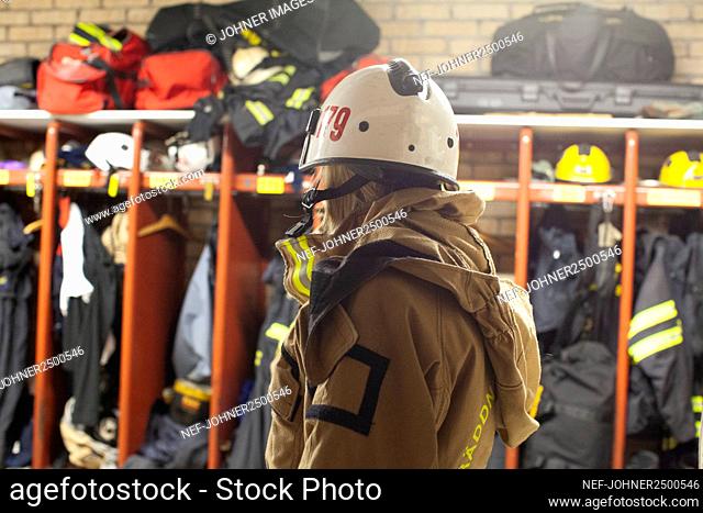 Female firefighter in locker