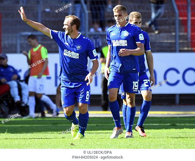 Karlsruhe's Erwin Hoffer celebrates his 1-0 goal with Grischa Proemel (C) and Enrico Valentini in the background at the German 2nd Bundesliga soccer match...